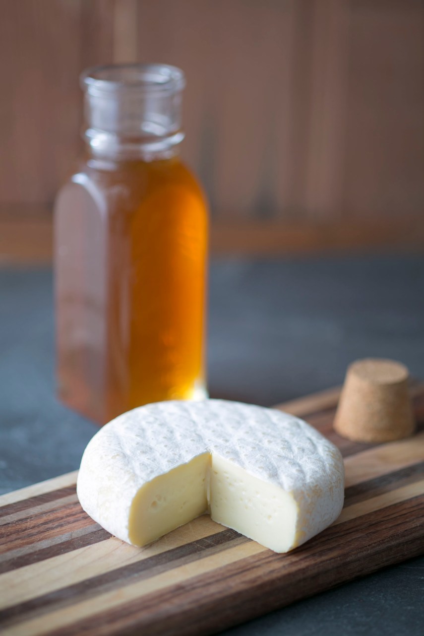 soft cheese and honey on cutting board